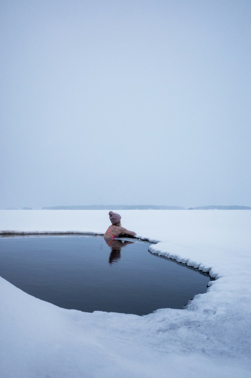 Woman in ice water experiencing cold plunge benefits