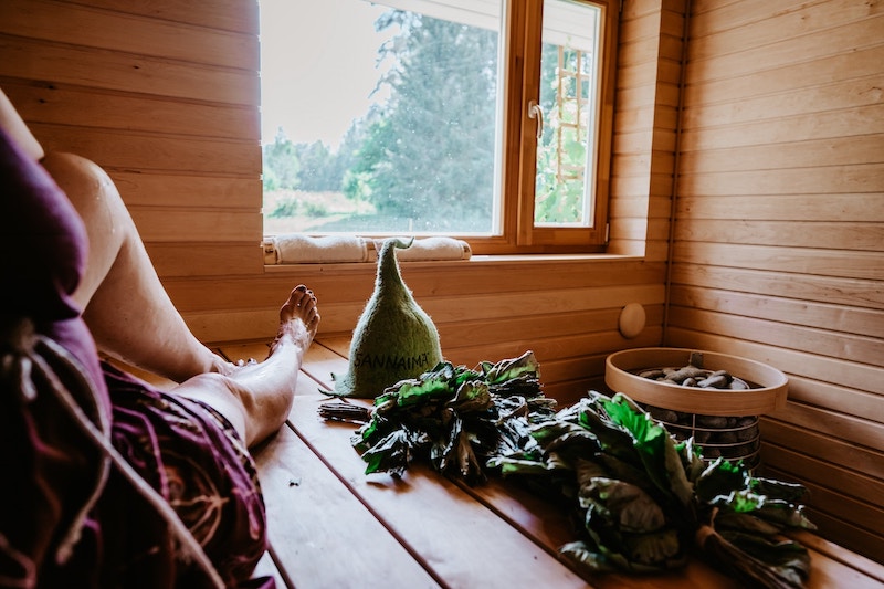 woman using sauna whisks