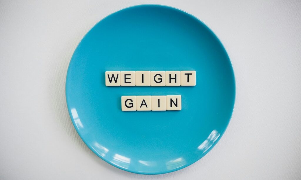 Words on a blue plate that read, "weight gain"